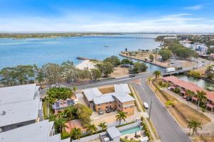 an aerial view of a town next to the water at Cloud 8 on Welsby in Bongaree