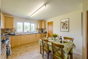 a kitchen with a table with chairs and a dining room at 3 Bed in Hawes oc-s30429 in Hawes