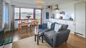 a living room with a couch and a table at 1 Bed in Reef oc-r30134 in Uig +12 photos