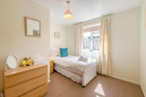 a bedroom with a bed and a mirror and a window at 3 Bed in Hawes oc-s30429 in Hawes