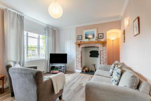 a living room with a couch and a fireplace at 3 Bed in Beer oc-b31132 in Beer