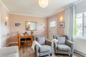 a living room with two chairs and a table at 3 Bed in Beer oc-b31132 in Beer