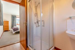 a bathroom with a shower and a sink at 3 Bed in Strathkanaird oc-r30948 in Ullapool +24 photos