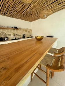 a wooden table in a kitchen with a bowl on it at Arenas Blancas VILLA 1 in Uluwatu