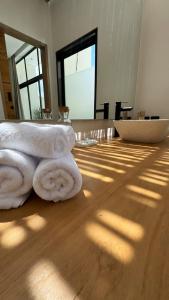 a stack of towels sitting on a wooden floor at Arenas Blancas VILLA 1 in Uluwatu