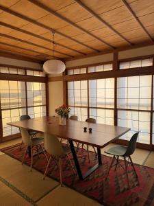 a dining room with a large wooden table and chairs at Blanco Escape in Myoko