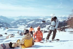 a group of people on top of a snow covered mountain at Blanco Escape in Myoko