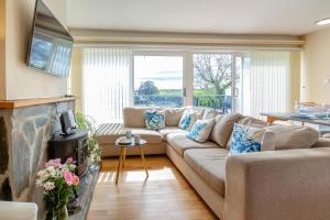 a living room with a couch and a fireplace at 2 Bed in Abersoch oc-c31969 in Abersoch