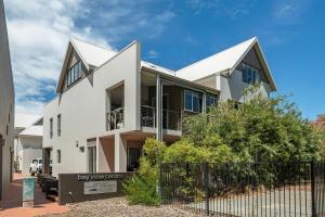 a white house with a fence in front of it at Apt 9 'Delphinius' @ Bay View Centro, Dunsborough in Dunsborough