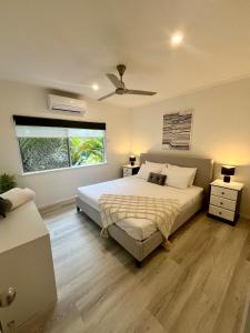 a bedroom with a bed and a ceiling fan at The Lazy Break at Trinity in Trinity Beach +19 photos