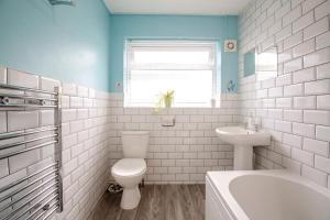 a white bathroom with a toilet and a sink at 2 Bed in Abersoch oc-c31969 in Abersoch +17 photos
