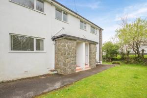 a white house with a lawn in front of it at 2 Bed in Abersoch oc-c31969 in Abersoch