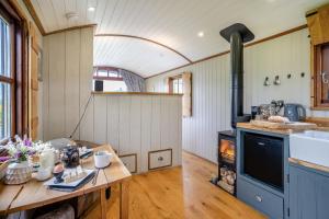 a kitchen with a table and a stove in a room at 1 Bed in Bronllys oc-t31950 in Bronllys