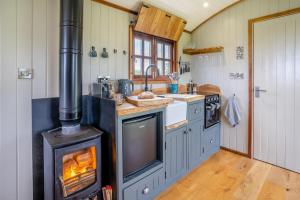 a kitchen with an oven with a fire in it at 1 Bed in Bronllys oc-t31950 in Bronllys +20 photos