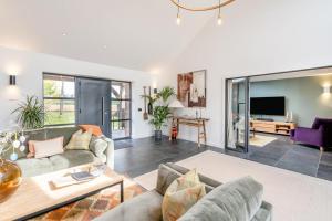a living room with two couches and a tv at 4 Bed in Rattray oc-e31983 in Alyth