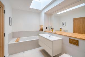 a bathroom with a white sink and a bath tub at 4 Bed in Rattray oc-e31983 in Alyth +41 photos