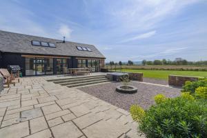 an external view of a house with a patio at 4 Bed in Rattray oc-e31983 in Alyth