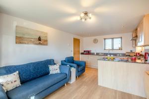 a living room with a blue couch and a kitchen at 2 Bed in West Bay oc-d31037 in West Bay