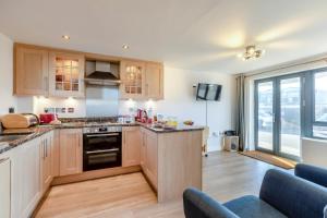a kitchen with wooden cabinets and a large window at 2 Bed in West Bay oc-d31037 in West Bay +5 photos