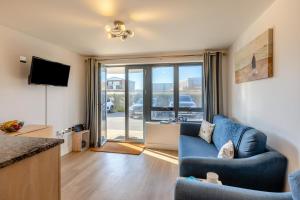 a living room with a blue couch and a television at 2 Bed in West Bay oc-d31037 in West Bay