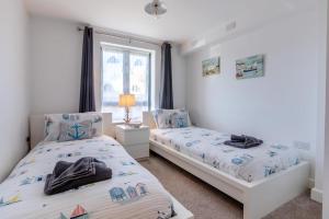 a bedroom with two beds and a window at 2 Bed in West Bay oc-d31037 in West Bay