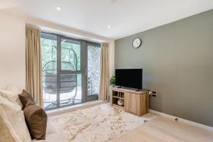 a living room with a tv and a large window at 1 Bed in Backbarrow oc-s32477 in Backbarrow