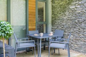 a blue table and chairs on a patio at 1 Bed in Backbarrow oc-s32477 in Backbarrow
