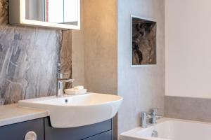 a bathroom with a white sink and a tub at 2 Bed in Langton Matravers oc-d28351 in Langton Matravers +17 photos
