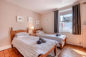 a bedroom with two beds and a window at 2 Bed in Langton Matravers oc-d28351 in Langton Matravers