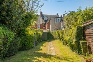 a hedge alley with a house in the background at 2 Bed in Langton Matravers oc-d28351 in Langton Matravers