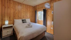 a bedroom with a bed and a window at BIG4 Barham Holiday Park in Barham