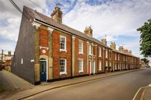 a row of brick houses on the side of a street at 2 Bed in Southwold oc-aathco in Southwold