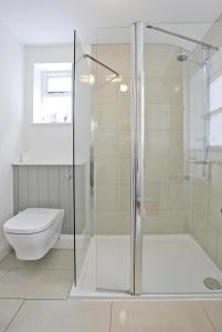 a bathroom with a shower and a toilet at 2 Bed in Southwold oc-aathco in Southwold +5 photos