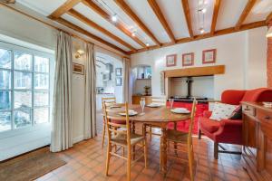 a kitchen and living room with a wooden table and chairs at 4 Bed in Barham oc-ct016 in Barham