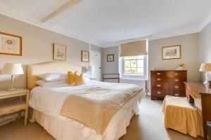 a bedroom with a large white bed and a dresser at 4 Bed in Barham oc-ct016 in Barham