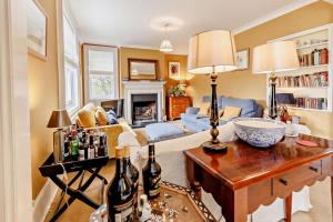 a living room with a table with bottles on it at 5 Bed in Sedlescombe oc-l27505 in Sedlescombe