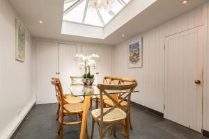 a dining room with a table and chairs and a skylight at 5 Bed in Sedlescombe oc-l27505 in Sedlescombe