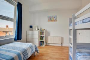 a bedroom with a bunk bed and a book shelf at 2 Bed in Hunstanton oc-1778 in Hunstanton