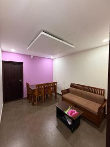 a living room with a couch and a table at Wayanad Cocos Villa in Tariyod