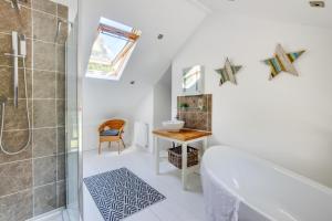 a bathroom with a tub and a shower and a sink at 2 Bed in Breage oc-jobcot in Breage +18 photos