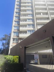 a large white apartment building with a gate in front of it at Valparaiso01 in Valparaíso +2 photos
