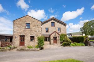 a large stone house with a driveway at 4 Bed in Hawes oc-ds940 in Hawes
