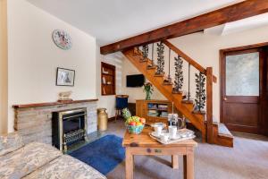 a living room with a fireplace and a staircase at 4 Bed in Hawes oc-ds940 in Hawes