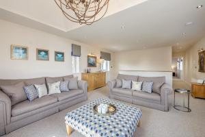 a living room with two couches and a table at 3 Bed in Bamburgh oc-gd0468 in Bamburgh