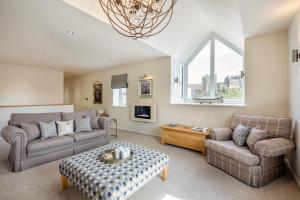 a living room with two couches and a table at 3 Bed in Bamburgh oc-gd0468 in Bamburgh