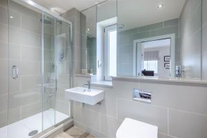 a bathroom with a sink and a shower and a mirror at 3 Bed in Bamburgh oc-gd0468 in Bamburgh +38 photos