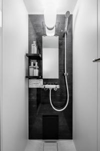 a bathroom with a shower with a light on the wall at Astage Villa Kamifurano in Kami-furano +69 photos