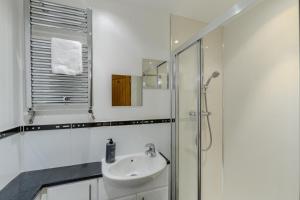 a white bathroom with a sink and a shower at 4 Bed in North Sunderland oc-gd1890 in North Sunderland +17 photos