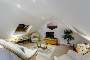 a living room with white furniture and a tv at 4 Bed in North Sunderland oc-gd1890 in North Sunderland