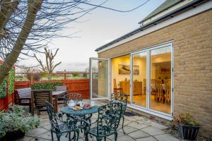 a patio with a table and chairs on a patio at 4 Bed in North Sunderland oc-gd1890 in North Sunderland